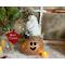 This image shows a Christmas Elf Decoration. It is made using a dried gourd. This elf's name is Tinsel and is wearing a handmade hat. 